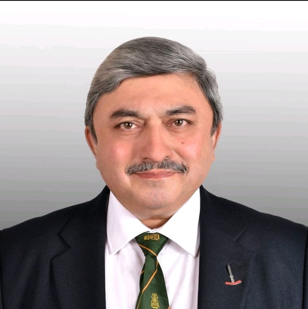 A man in a blue jacket and white shirt.